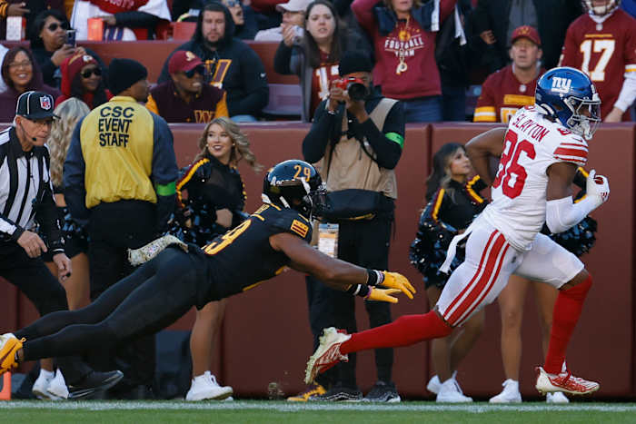 New York Giants wide receiver Darius Slayton (86) runs with the ball past Washington Commanders cornerback Kendall Fuller (29) en route to a touchdown during the second quarter at FedExField.